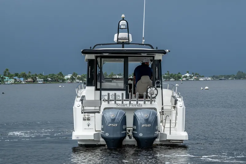  Yacht Photos Pics 2021 Jeanneau NC Sport 895 boat on water, rear view, with dual Yamaha engines.