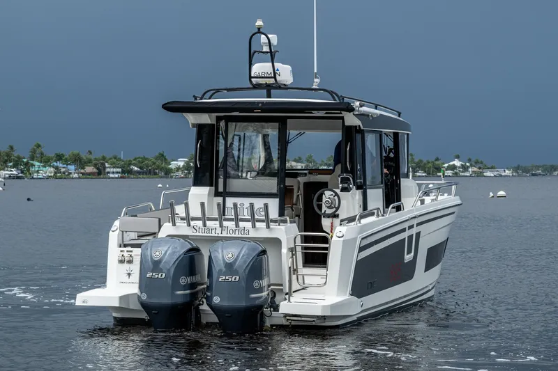  Yacht Photos Pics 2021 Jeanneau NC Sport 895 boat with dual Yamaha 250 engines on a calm waterway.