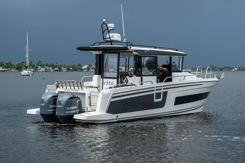  Yacht Photos Pics 2021 Jeanneau NC Sport 895 boat with twin Yamaha engines on calm water.