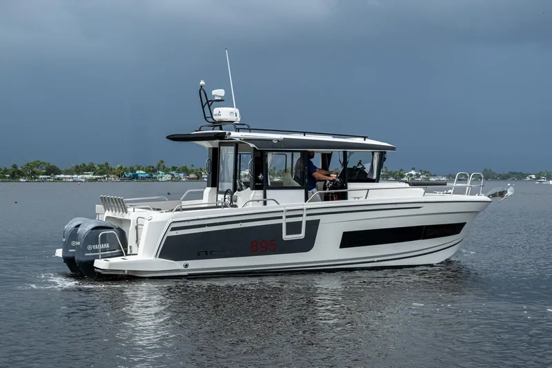  Yacht Photos Pics 2021 Jeanneau NC Sport 895 boat on water, featuring Yamaha engines, under cloudy sky.