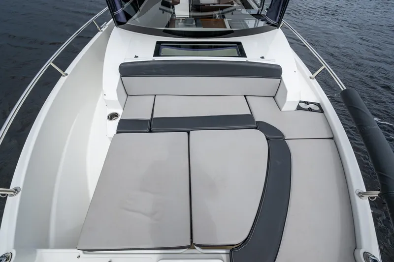  Yacht Photos Pics 2021 Jeanneau NC Sport 895 boat with spacious deck seating on water.