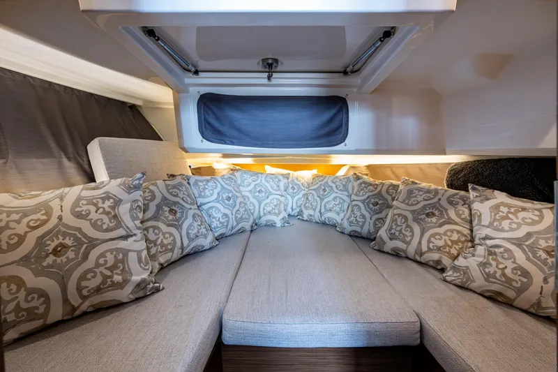  Yacht Photos Pics Cozy cabin interior of 2021 Jeanneau NC Sport 895 with patterned cushions.