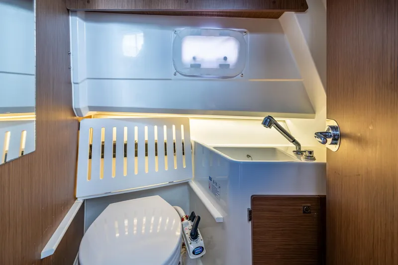  Yacht Photos Pics 2021 Jeanneau NC Sport 895 boat bathroom with sink and toilet.