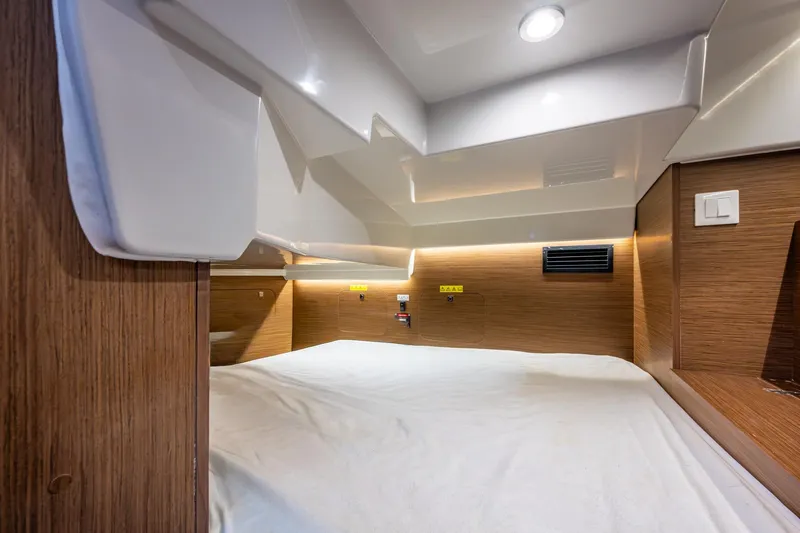  Yacht Photos Pics 2021 Jeanneau NC Sport 895 cabin interior with wood paneling and modern lighting.