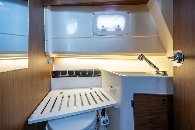  Yacht Photos Pics 2021 Jeanneau NC Sport 895 bathroom with sink, faucet, and compact design.