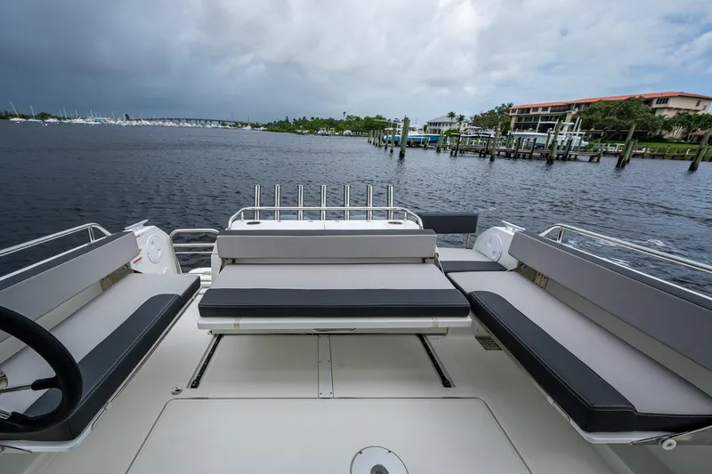  Yacht Photos Pics 2021 Jeanneau NC Sport 895 boat interior with seating, docked by a marina.