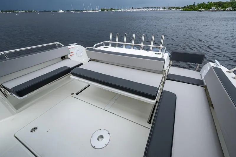  Yacht Photos Pics 2021 Jeanneau NC Sport 895 boat deck with seating, overlooking calm waters.