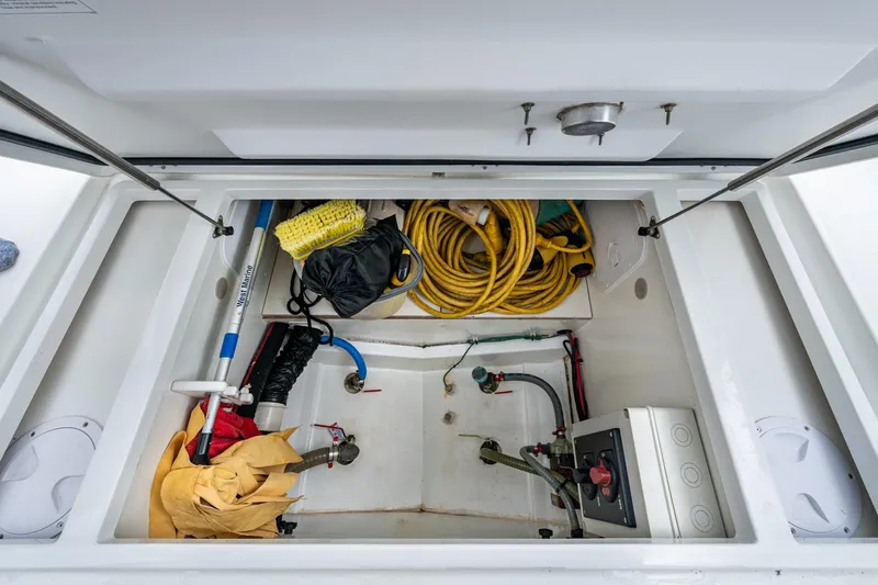  Yacht Photos Pics Storage compartment of 2021 Jeanneau NC Sport 895 boat with equipment and supplies.