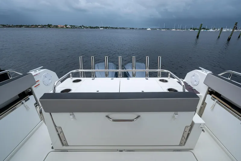  Yacht Photos Pics 2021 Jeanneau NC Sport 895 boat deck with rod holders, overlooking calm waters.