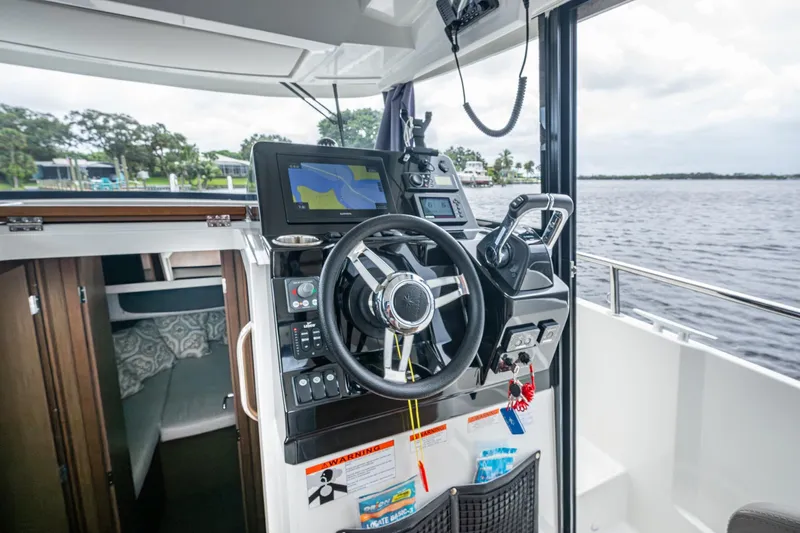  Yacht Photos Pics 2021 Jeanneau NC Sport 895 helm with navigation system and water view.