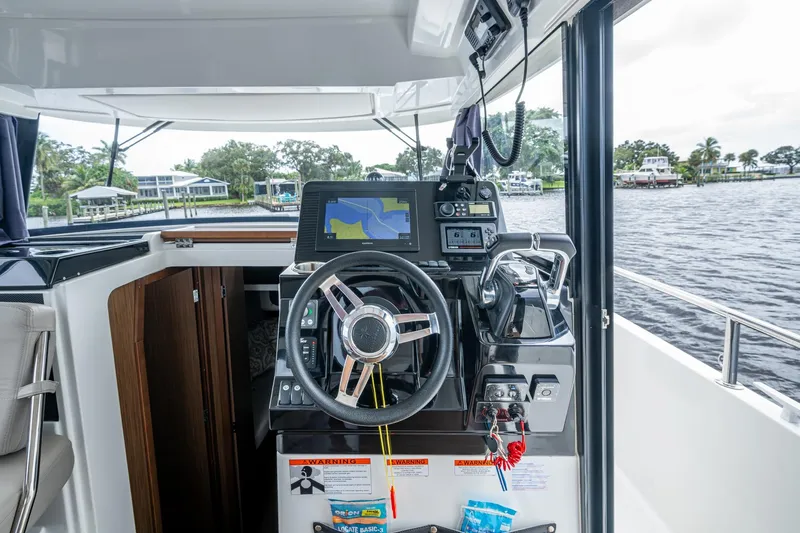  Yacht Photos Pics 2021 Jeanneau NC Sport 895 helm with navigation system, steering wheel, and throttle controls.