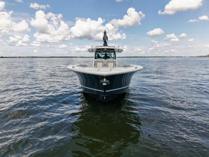 Lucky 24 II Yacht Photos Pics 2023 Scout 400 LXF boat on open water under a partly cloudy sky.