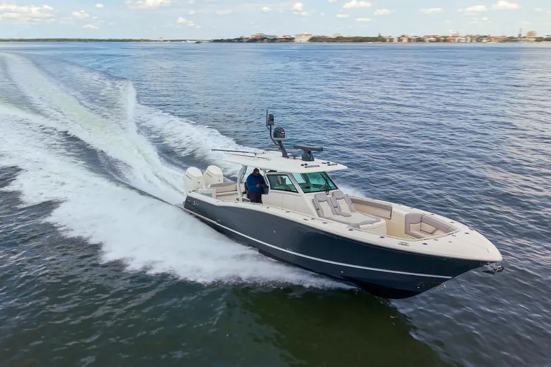 Lucky 24 II Yacht Photos Pics 2023 Scout 400 LXF boat cruising on open water, showcasing sleek design and powerful performance.