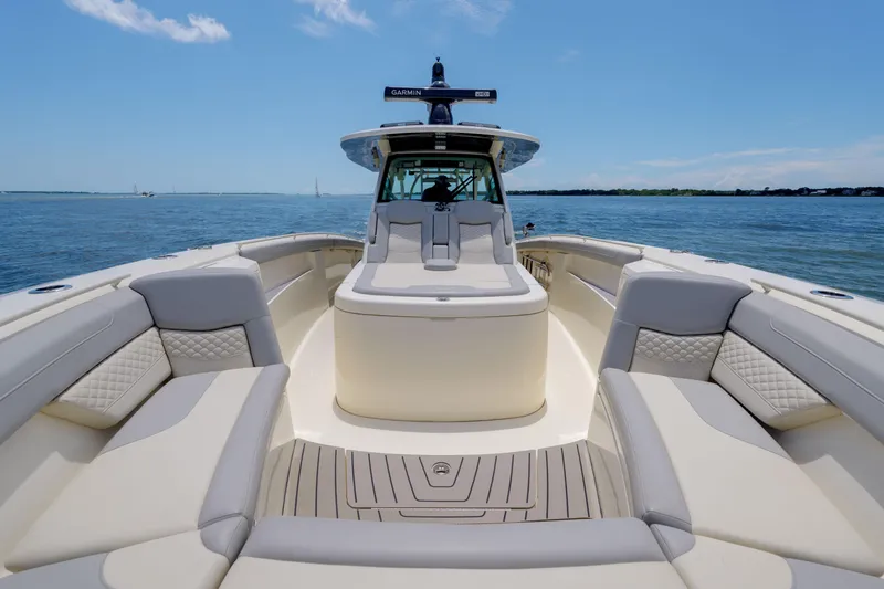 Lucky 24 II Yacht Photos Pics 2023 Scout 400 LXF luxury boat interior with cushioned seating on open water.