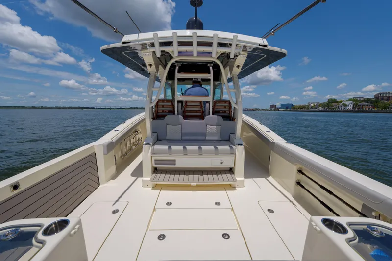 Lucky 24 II Yacht Photos Pics 2023 Scout 400 LXF boat on water, featuring spacious deck and seating.