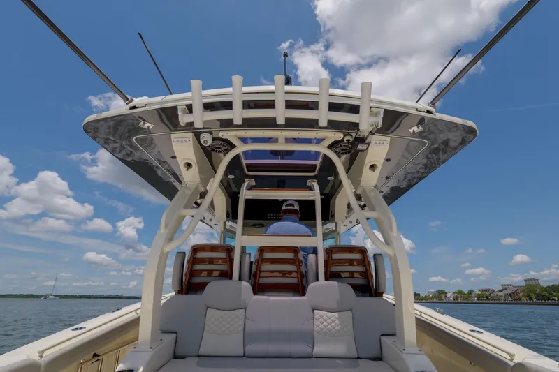 Lucky 24 II Yacht Photos Pics 2023 Scout 400 LXF boat on water, viewed from rear, under clear blue sky.
