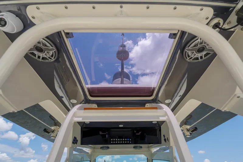 Lucky 24 II Yacht Photos Pics 2023 Scout 400 LXF boat interior with skylight and speakers, showcasing modern design.