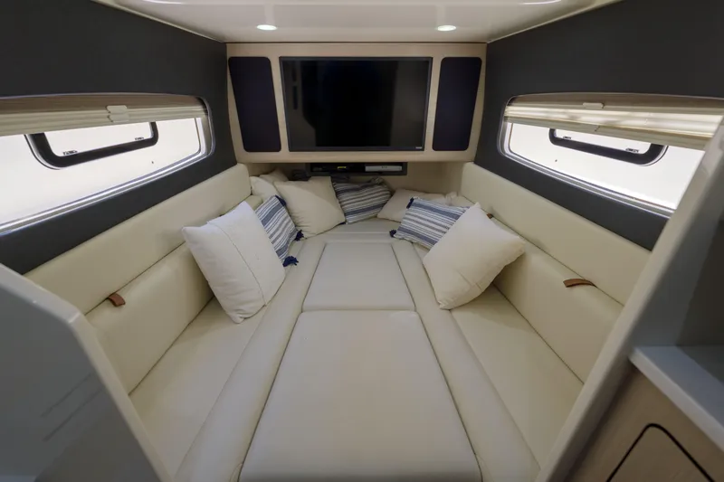 Lucky 24 II Yacht Photos Pics Luxurious interior cabin of 2023 Scout 400 LXF boat with plush seating and windows.