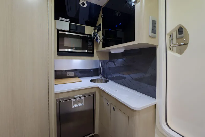 Lucky 24 II Yacht Photos Pics 2023 Scout 400 LXF boat interior kitchen with modern appliances and sleek design.