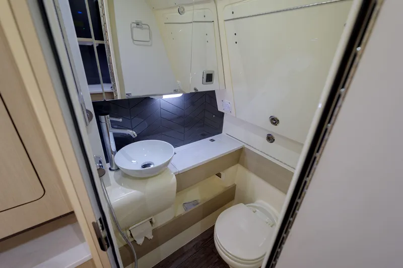 Lucky 24 II Yacht Photos Pics 2023 Scout 400 LXF boat bathroom with modern sink and toilet.