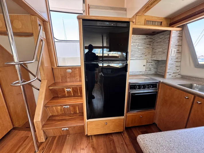  Yacht Photos Pics Interior of 1996 Carver 500 Cockpit Motor Yacht with kitchen and wooden stairs.