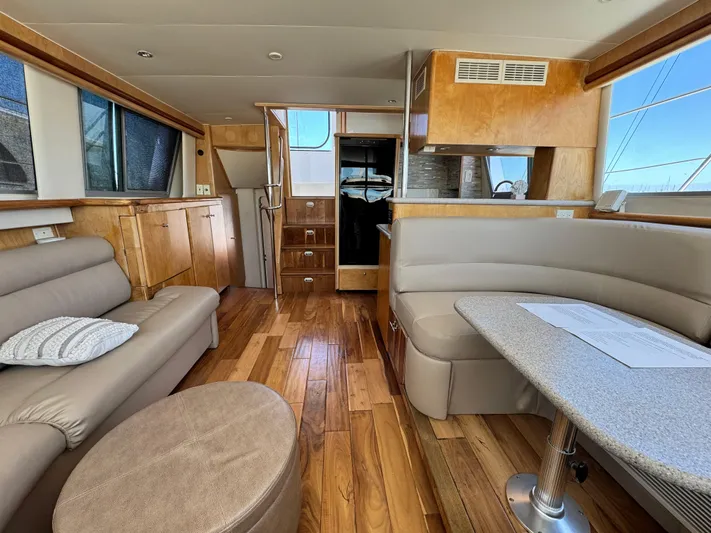  Yacht Photos Pics Interior of 1996 Carver 500 Cockpit Motor Yacht with wood flooring and beige seating.