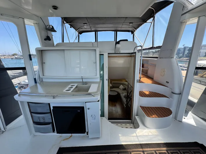  Yacht Photos Pics 1996 Carver 500 Cockpit Motor Yacht interior with kitchenette and stairs, docked at marina.