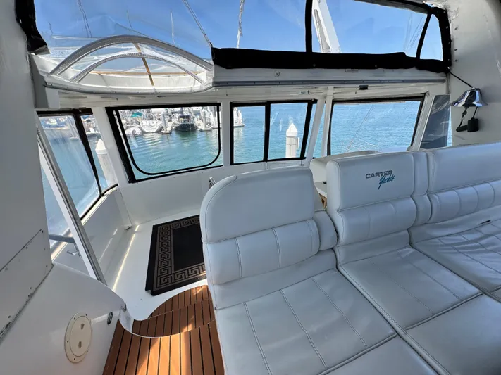  Yacht Photos Pics Interior of a 1996 Carver 500 Cockpit Motor Yacht with white seating and marina view.