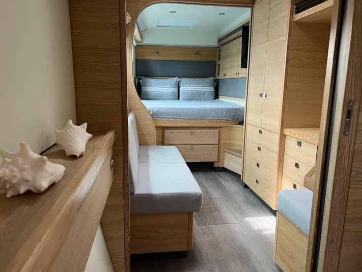 Levante Yacht Photos Pics Luxurious interior of 2022 Xquisite Yachts X5 PLUS with elegant wood finish and cozy bedroom.