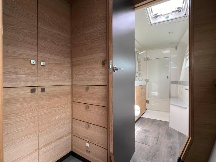 Levante Yacht Photos Pics Luxurious bathroom interior of 2022 Xquisite Yachts X5 PLUS with wood cabinetry and modern fixtures.