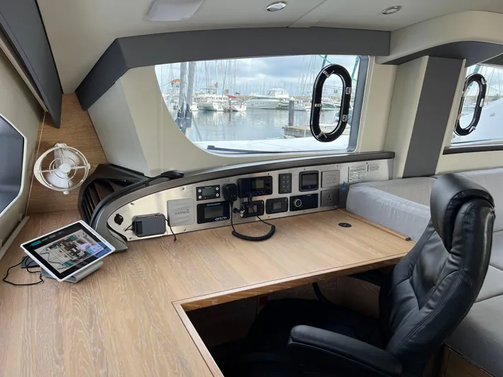 Levante Yacht Photos Pics Luxurious 2022 Xquisite Yachts X5 PLUS interior with modern navigation desk and marina view.