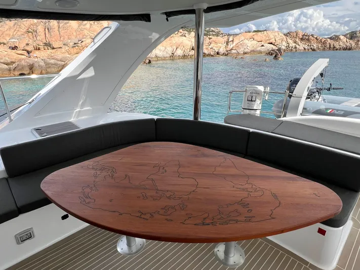 Levante Yacht Photos Pics Luxurious 2022 Xquisite Yachts X5 PLUS with elegant wooden table, scenic ocean view.