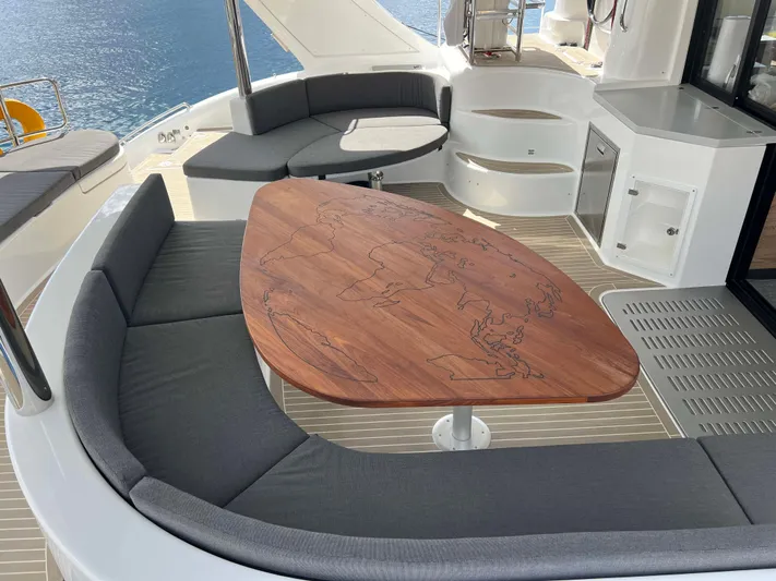 Levante Yacht Photos Pics Luxurious 2022 Xquisite Yachts X5 PLUS with elegant outdoor seating and wooden table.