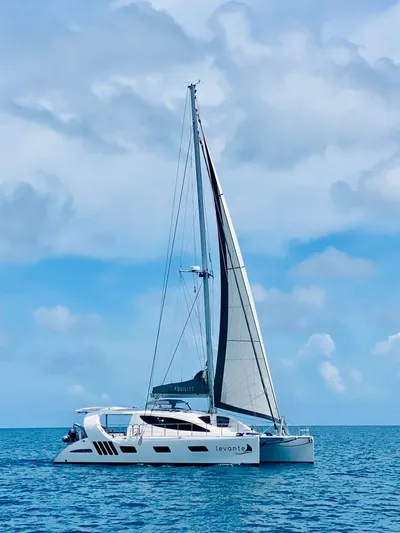 Levante Yacht Photos Pics 2022 Xquisite Yachts X5 PLUS sailing catamaran on open sea under blue sky.