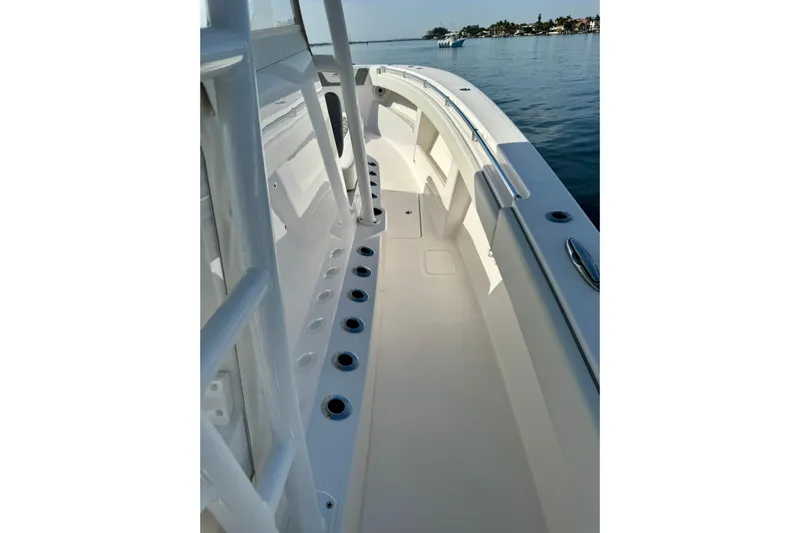 All Eyez On Me Yacht Photos Pics 2024 Invincible 39 Open Fisherman boat deck with rod holders, on calm water.