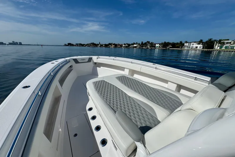 All Eyez On Me Yacht Photos Pics 2024 Invincible 39 Open Fisherman boat on calm waters, luxury seating, clear sky.