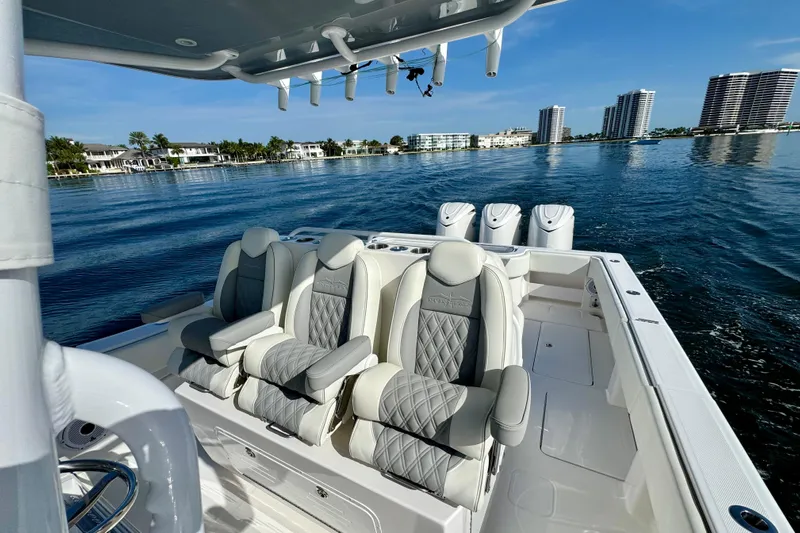 All Eyez On Me Yacht Photos Pics 2024 Invincible 39 Open Fisherman boat with luxurious seating on calm waters.