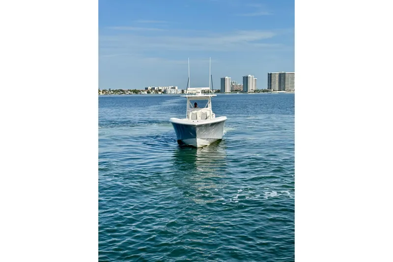 All Eyez On Me Yacht Photos Pics 2024 Invincible 39 Open Fisherman boat on calm water with city skyline.