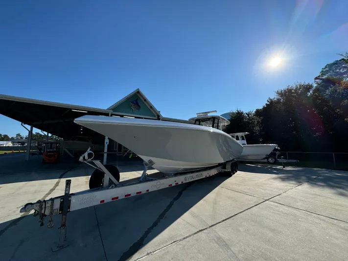  Yacht Photos Pics 2025 Fountain 38TE boat on trailer under clear blue sky.
