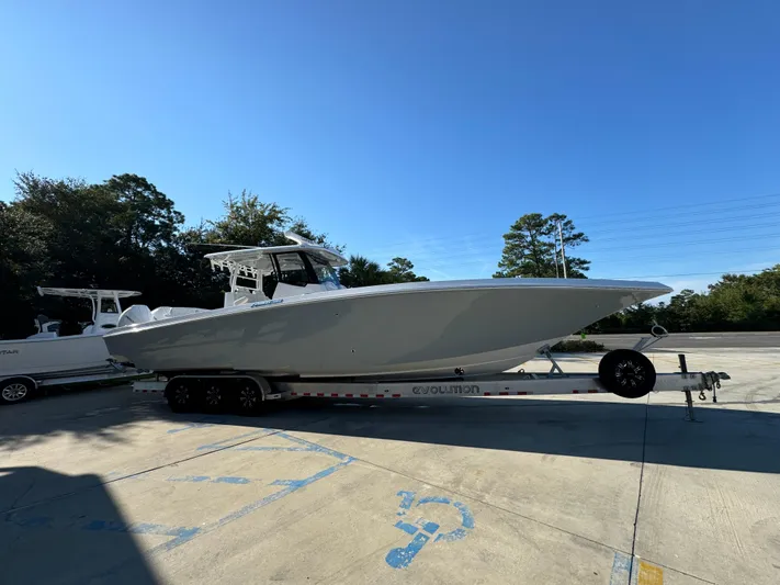  Yacht Photos Pics 2025 Fountain 38TE boat on trailer in sunny outdoor setting.