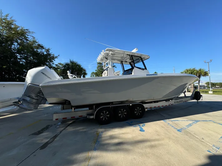  Yacht Photos Pics 2025 Fountain 38TE boat on trailer, parked outdoors under clear blue sky.