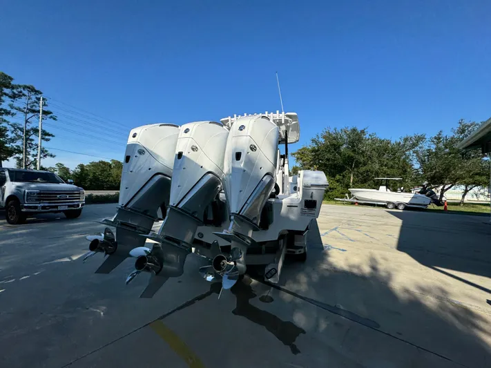  Yacht Photos Pics 2025 Fountain 38TE boat with triple outboard engines in a sunny outdoor setting.