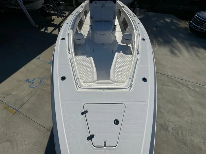  Yacht Photos Pics 2025 Fountain 38TE boat deck, white with seating and storage compartments.