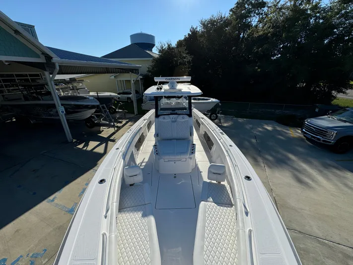  Yacht Photos Pics 2025 Fountain 38TE boat docked, showcasing sleek design and spacious deck.