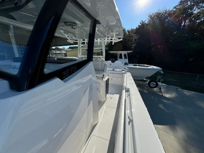  Yacht Photos Pics 2025 Fountain 38TE boat docked under sunlight, showcasing sleek design and modern features.