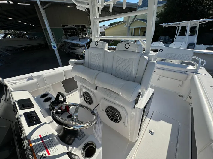  Yacht Photos Pics 2025 Fountain 38TE boat interior with white seating and modern steering console.