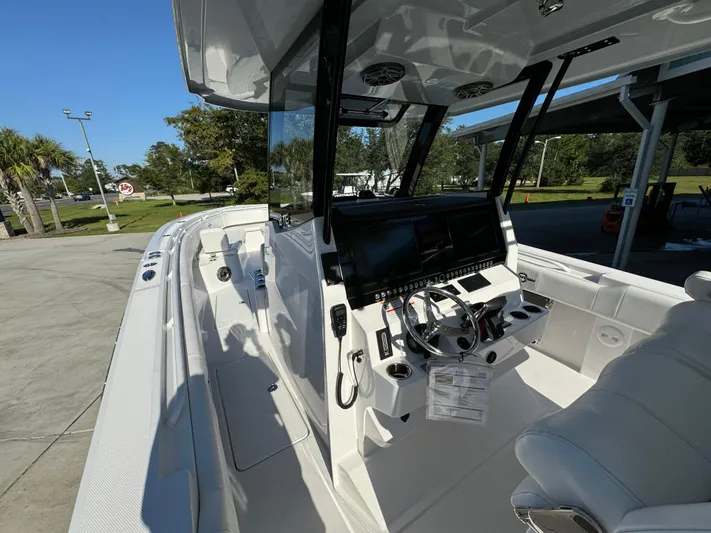  Yacht Photos Pics 2025 Fountain 38TE boat interior with modern dashboard and seating.