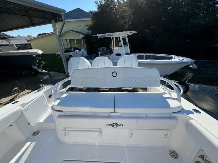  Yacht Photos Pics 2025 Fountain 38TE boat with white seating, docked outdoors.