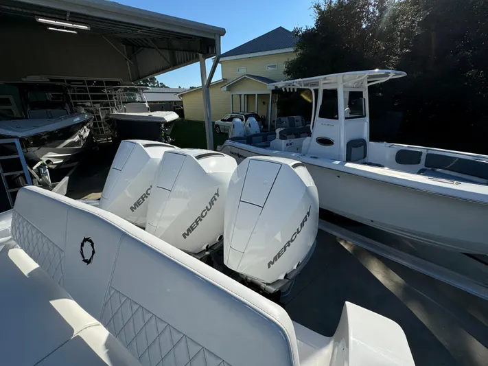  Yacht Photos Pics 2025 Fountain 38TE boat with triple Mercury outboard engines in a marina setting.