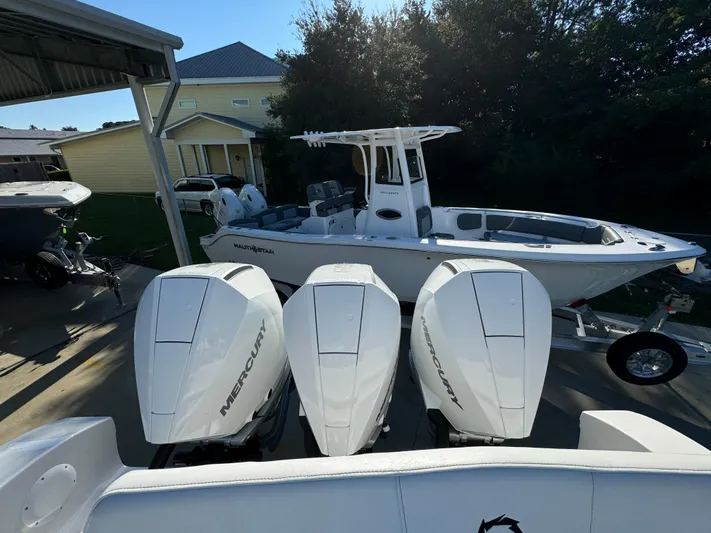  Yacht Photos Pics 2025 Fountain 38TE boat with triple Mercury engines, parked outdoors.
